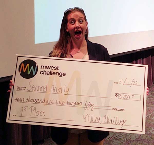 Student holding large check