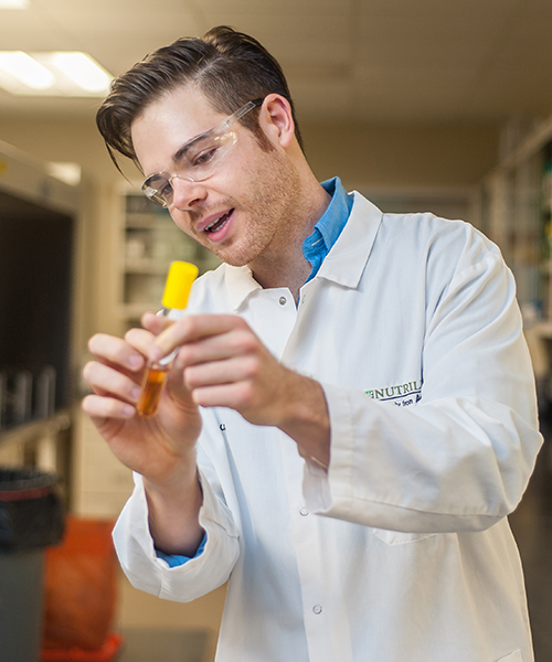 alumni holding test tube