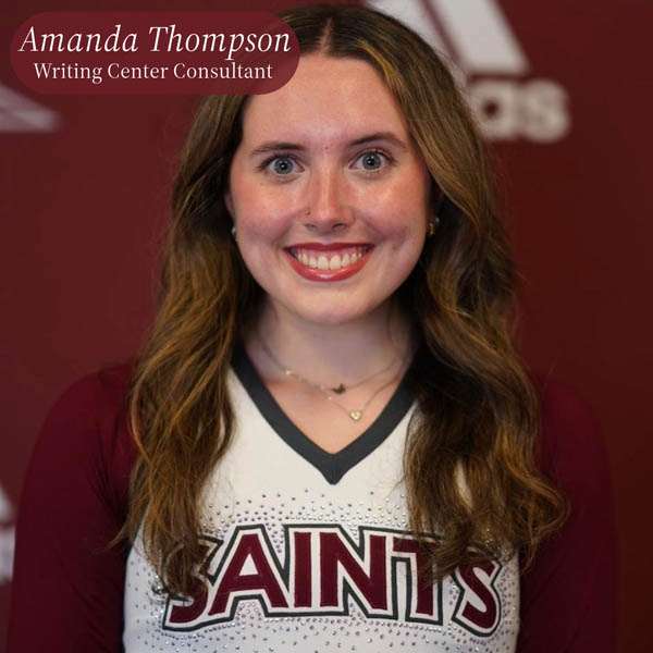 Headshot of a girl with long brown hair, in an Aquinas College cheerleading uniform, in front of a maroon background. Text reading: Amanda Thompson, Writing Center Consultant.