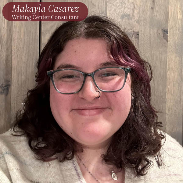 Selfie of a girl with shoulder length brown hair, glasses, and a nose ring in front of a wood wall. Text reading: Makayla Casarez, Writing Center Consultant