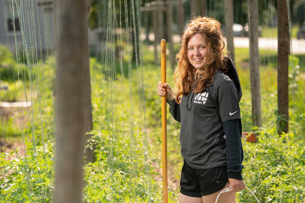 student with shovel in garden