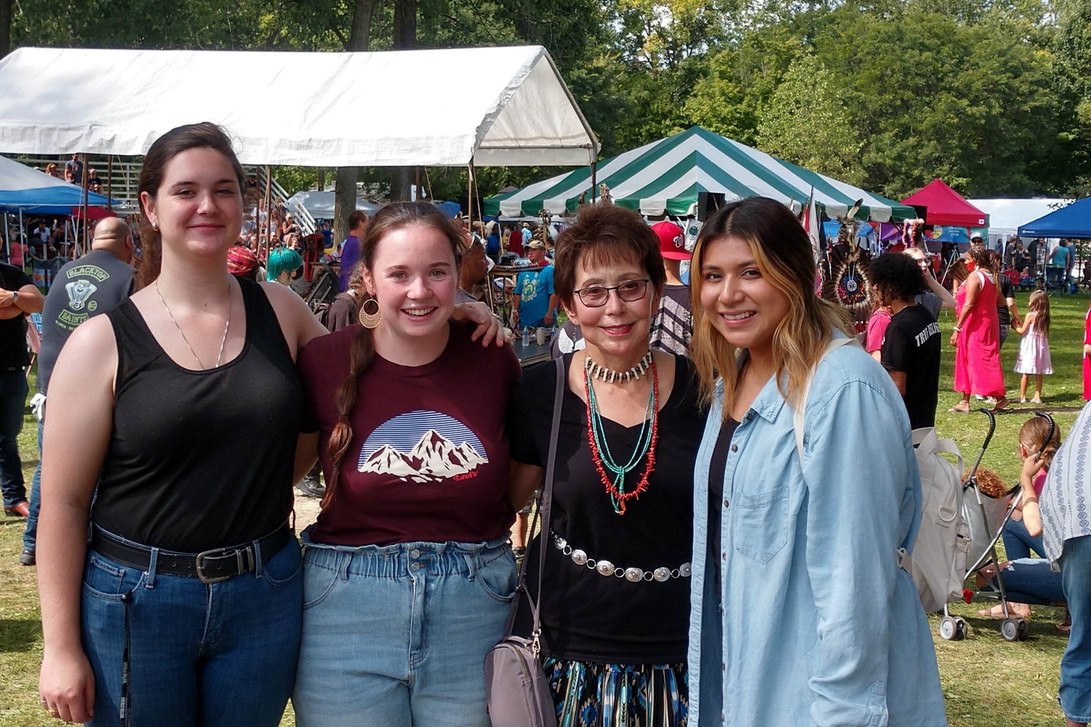 students with professor at powwow